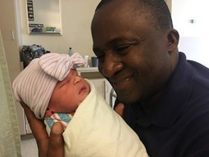 Adoptive parent holds his new baby grateful for adopting through highly successful Lifetime Adoption